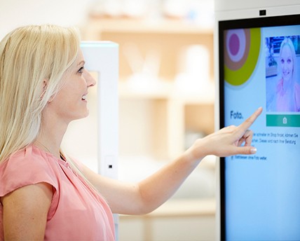 Woman at self-service kiosk