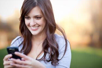 A portrait of a woman texting with her phone A portrait of a woman texting with her phone image small
