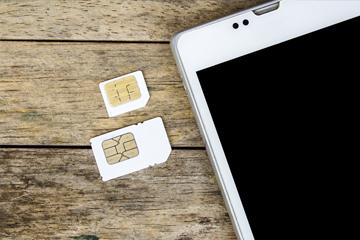 Sim cards next to mobile phone Sim cards next to mobile phone image small